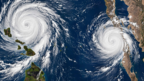 Satellite-style view of twin hurricanes Nolo and Polo churning over the Pacific Ocean near Hawaii and Baja California, Mexico.
