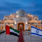 Abu Dhabi's presidential palace at dusk with the flags of the UAE and Israel flying side by side