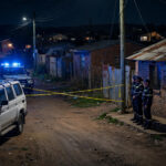 Night-time police cordon in a South African township after mass shootings near Johannesburg and Cape Town.