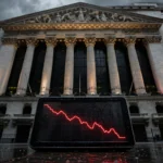New York Stock Exchange under a dark sky with a screen showing a falling red stock chart, symbolising Monday's market selloff
