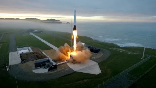 Rocket Lab Electron rocket launching at dawn from Launch Complex 1 on New Zealand's Māhia Peninsula