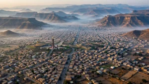 Aerial view of Mekelle, the capital of Ethiopia's Tigray region, nestled among highland mountains at dawn.