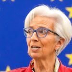 Christine Lagarde speaking at a European Parliament plenary session, before the blue European Union flag with gold stars. File photo, March 2022.
