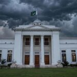 Editorial illustration of a provincial assembly building in Peshawar under stormy skies, symbolising the constitutional standoff between Khyber Pakhtunkhwa's chief minister and governor