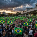 A crowd of Brazilian voters waving national flags outside a polling station in São Paulo at dusk on election day