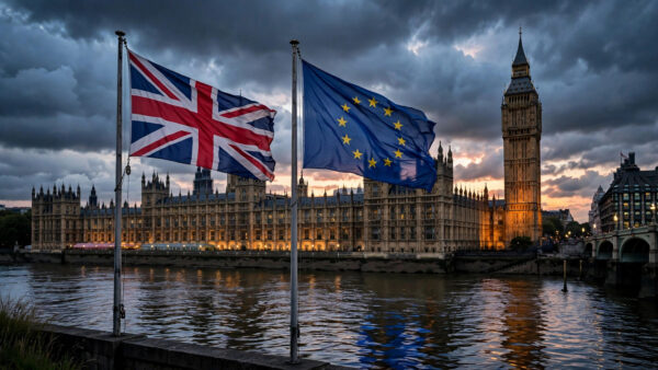 Palace of Westminster at dusk with Union Jack and European Union flags flying side by side above the River Thames