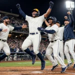 Milwaukee Brewers players celebrating Jackson Chourio's walk-off win over the San Diego Padres in Game 2 of the NLDS at night