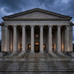 A grand neoclassical US federal courthouse facade with tall stone columns at dusk