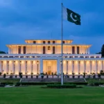 Aiwan-e-Sadr, Pakistan's Presidency in Islamabad, illuminated at dusk with the Pakistani flag flying — the venue of Thursday's Shehbaz-Zardari meeting.