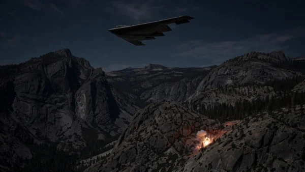 A B-2 stealth bomber flying over mountainous terrain at night during a military strike