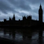 The Houses of Parliament in Westminster, London, at dusk under a dark sky