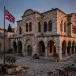 A historic limestone consulate building in East Jerusalem at dusk with the Union Jack flag flying, which Israel is set to close on Thursday in a diplomatic row over Britain's settlement trade ban.