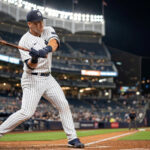 New York Yankees batter swinging at night during the AL Wild Card Series sweep of the Boston Red Sox at Yankee Stadium